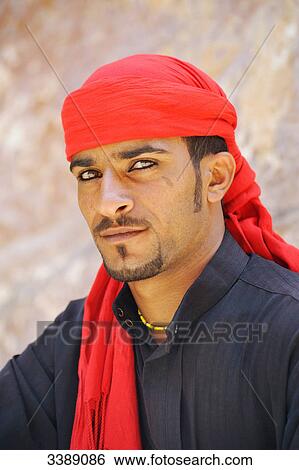 Stock Photograph - Man with red scarf on his head, portrait . Fotosearch