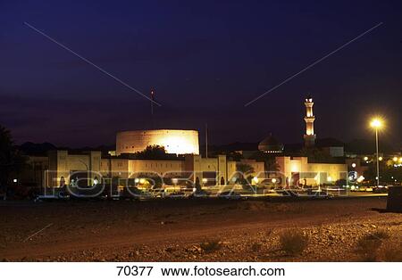 Stock Photo - Mosque in town lit up at night, Nizwa, Oman . Fotosearch