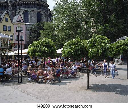 People sitting at sidewalk cafe, North Rhine-Westphalia, Germany View Large Photo Image Stock Photo - People sitting at sidewalk cafe, North Rhine-Westphalia, Germany . Fotosearch
