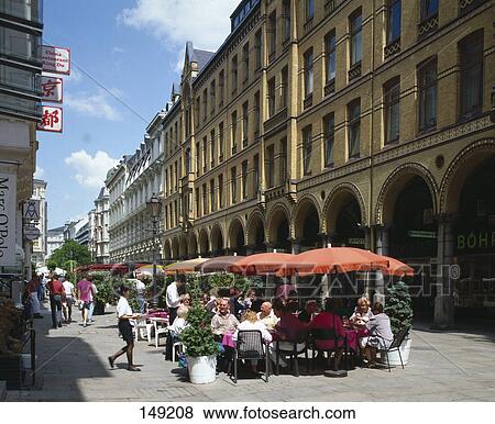 Stock Photo - People sitting at sidewalk cafe, Hamburg, Germany . Fotosearch