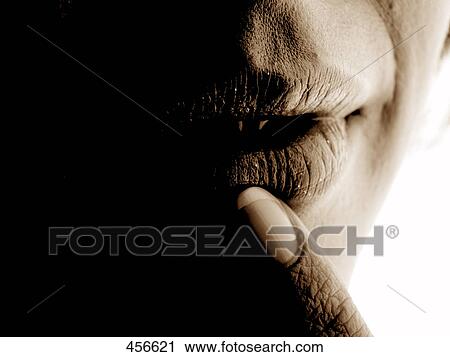 Stock Image - person tipping her lip, close-up . Fotosearch