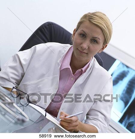 Portrait of female doctor sitting in hospital View Large Photo Image Stock Photo - Portrait of female doctor sitting in hospital . Fotosearch