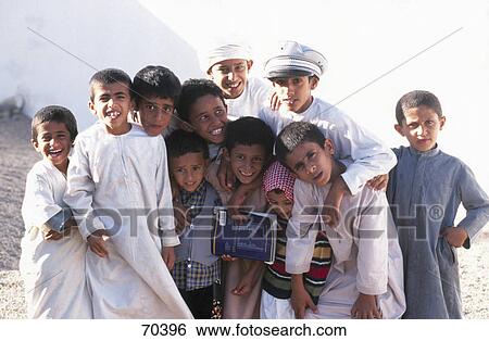 Stock Photograph - Portrait of group of children smiling, Oman . Fotosearch