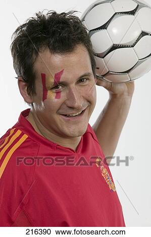 Portrait of male soccer fan holding soccer ball and smiling View Large Photo Image Stock Image - Portrait of male soccer fan holding soccer ball and smiling . Fotosearch