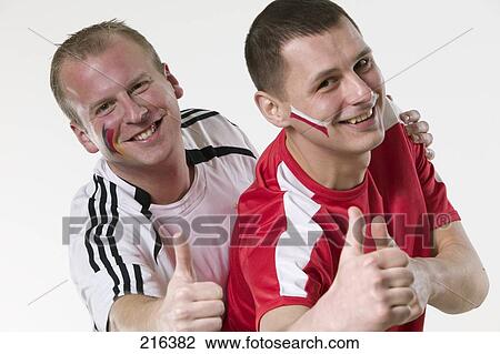 Portrait of two male soccer fans showing thumbs up View Large Photo Image Stock Image - Portrait of two male soccer fans showing thumbs up . Fotosearch