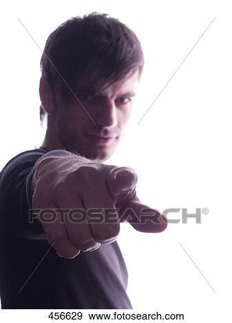 Portrait of young man pointing View Large Photo Image Stock Photo - Portrait of young man pointing . Fotosearch