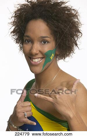 Stock Photo - Portrait of young woman with Brazilian flag painted on her face . Fotosearch