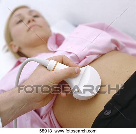Pregnant woman getting sonogram View Large Photo Image Stock Photo - Pregnant woman getting sonogram . Fotosearch