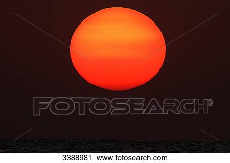 Red-coloured sun at sunset, close-up View Large Photo Image Stock Image - Red-coloured sun at sunset, close-up . Fotosearch