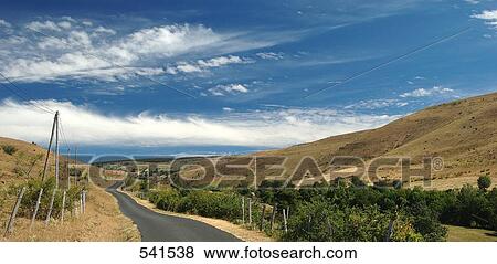 Stock Photo - Road passing through landscape, Les Bondons, Lozere, France . Fotosearch