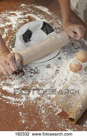 rolling pin rolling a football, elevated view  View Large Photo Image Stock Image - rolling pin rolling a football, elevated view . Fotosearch