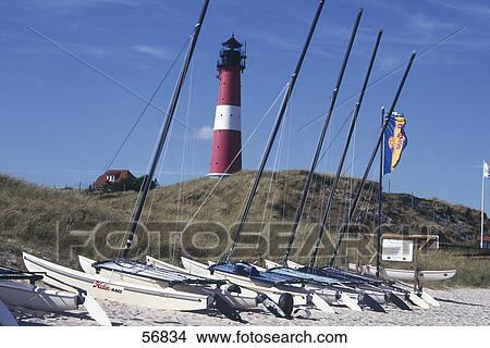 Sailboats on the beach in a row View Large Photo Image Picture - Sailboats on the beach in a row . Fotosearch