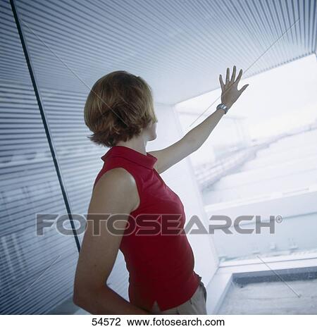 Side profile of businesswoman leaning against window glass View Large Photo Image Stock Image - Side profile of businesswoman leaning against window glass . Fotosearch