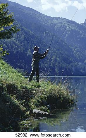 Side profile of man fly fishing at lakeside View Large Photo Image Stock Image - Side profile of man fly fishing at lakeside . Fotosearch