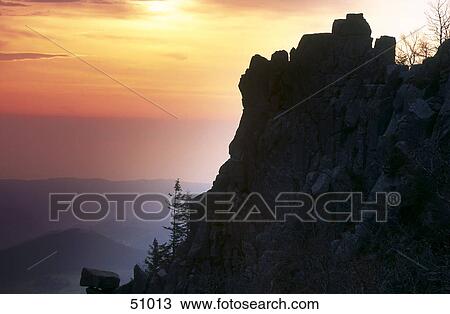 Stock Image - Silhouette of mountains at sunrise, Vosges, France . Fotosearch