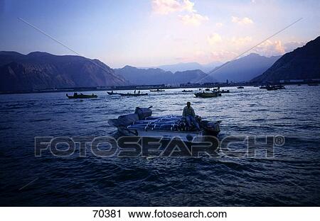 Silhouette of person on boat in sea, Musandam Peninsula, Oman, United Arab Emirates View Large Photo Image Stock Image - Silhouette of person on boat in sea, Musandam Peninsula, Oman, United Arab Emirates . Fotosearch