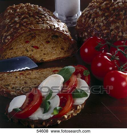 Slices of mozzarella and tomato on beard View Large Photo Image Stock Photo - Slices of mozzarella and tomato on beard . Fotosearch