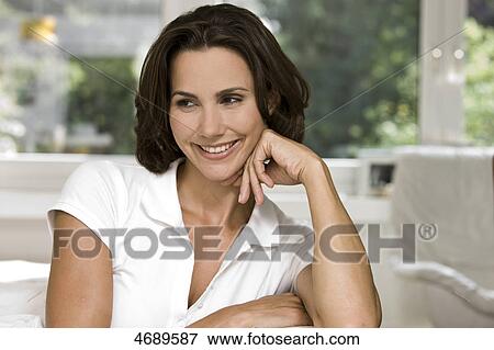 Smiling woman looking sideways View Large Photo Image Stock Photo - Smiling woman looking sideways . Fotosearch