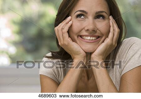 Smiling woman looking up View Large Photo Image Stock Image - Smiling woman looking up . Fotosearch