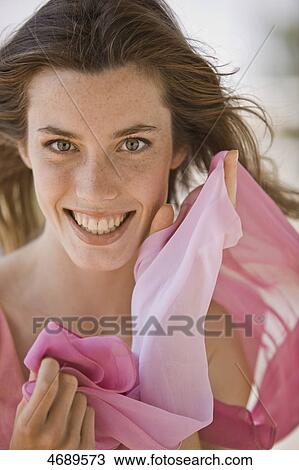 Stock Image - Smiling young woman with long brown hair . Fotosearch