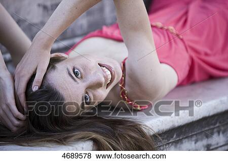 Stock Photo - Smiling young woman with long brown hair . Fotosearch