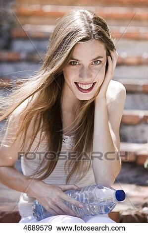 Smiling young woman with long brown hair View Large Photo Image Stock Photo - Smiling young woman with long brown hair . Fotosearch