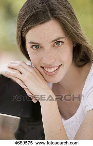 Smiling young woman with long brown hair View Large Photo Image Stock Photography - Smiling young woman with long brown hair . Fotosearch
