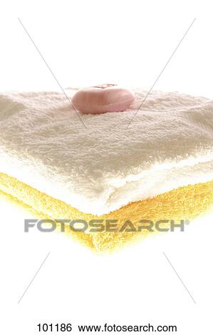 Stock Photograph - Soap on stack of towels . Fotosearch