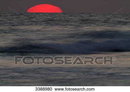 Stock Image - Sunset at the sea . Fotosearch