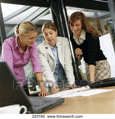 Three young woman having a meeting  View Large Photo Image Stock Photography - Three young woman having a meeting . Fotosearch