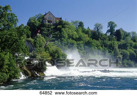 Tourists in a tour boat at the waterfalls, Rhine Falls, Schaffhausen, Switzerland View Large Photo Image Stock Image - Tourists in a tour boat at the waterfalls, Rhine Falls, Schaffhausen, Switzerland . Fotosearch