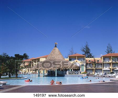 Stock Photo - Tourists swimming in swimming pool, Gran Ventana Beach Resort, Hotel Playa Dorada, Puerto Plata, Dominican Republic . Fotosearch