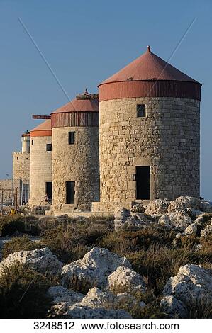 Stock Image - Tower mills at the harbour of Rhodes, Greece . Fotosearch