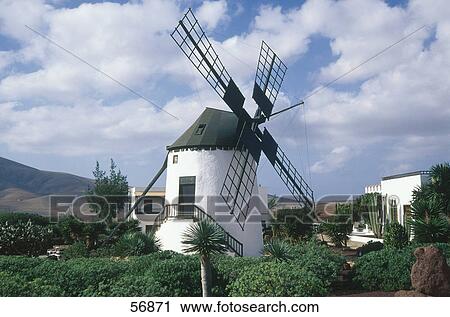 Traditional windmill under cloudy sky View Large Photo Image Stock Image - Traditional windmill under cloudy sky . Fotosearch