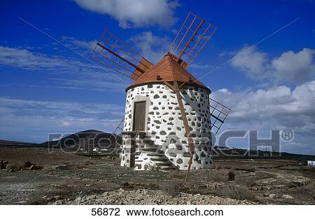 Traditional windmill under cloudy sky View Large Photo Image Stock Image - Traditional windmill under cloudy sky . Fotosearch