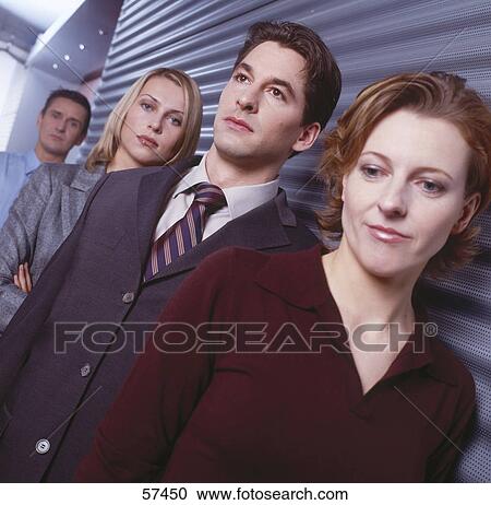 Two businessmen and businesswomen standing in row View Large Photo Image Stock Image - Two businessmen and businesswomen standing in row . Fotosearch