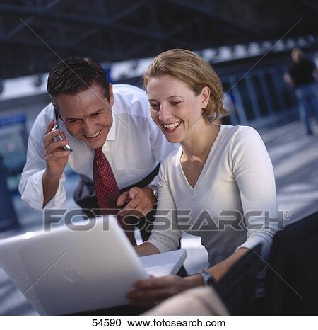 Two businesspeople with laptop and moblie phone View Large Photo Image Stock Image - Two businesspeople with laptop and moblie phone . Fotosearch