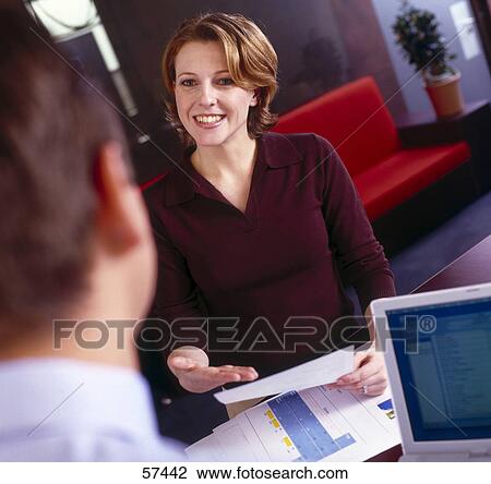 Stock Image - Two employees having a meeting . Fotosearch