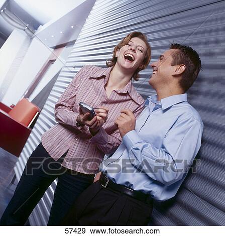 Two employees laughing View Large Photo Image Stock Photo - Two employees laughing . Fotosearch