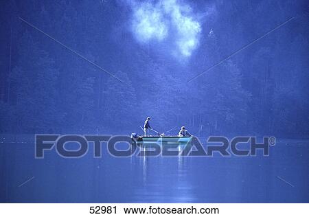 Stock Image - Two men fishing in lake . Fotosearch