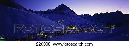 Stock Photo - Village in valley lit up at dusk, Austria . Fotosearch