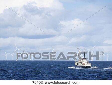 Stock Image - Wind turbines and ship in sea . Fotosearch