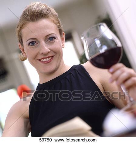 Woman drinking a glass of wine, low angle view View Large Photo Image Stock Image - Woman drinking a glass of wine, low angle view . Fotosearch