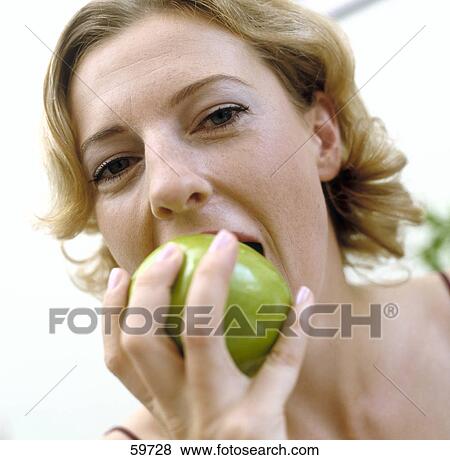 Woman eating an apple, close-up View Large Photo Image Stock Photo - Woman eating an apple, close-up . Fotosearch