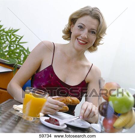 Woman having breakfast View Large Photo Image Picture - Woman having breakfast . Fotosearch