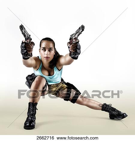 Woman holding two pistols, full shot View Large Photo Image Stock Photograph - Woman holding two pistols, full shot . Fotosearch