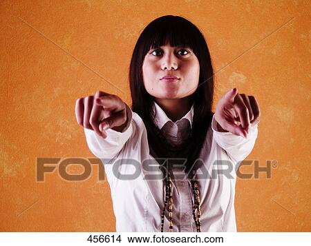 Woman pointing, front view View Large Photo Image Picture - Woman pointing, front view . Fotosearch