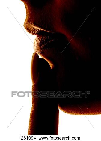 woman tipping with her finger her lip, close-up View Large Photo Image Picture - woman tipping with her finger her lip, close-up . Fotosearch