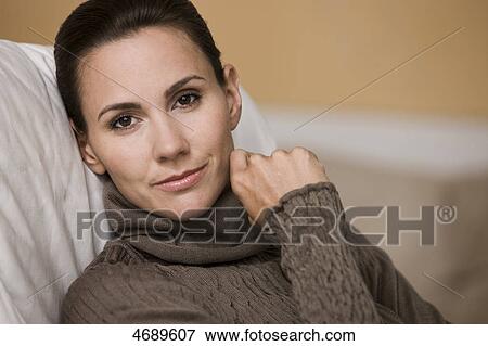 Stock Photo - Woman wearing brown pullover . Fotosearch