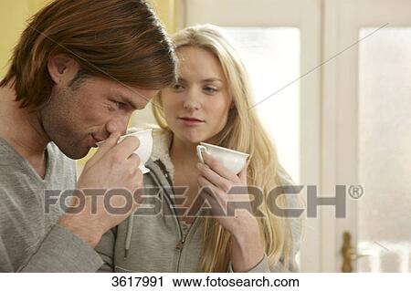 Young couple drinking coffee in kitchen View Large Photo Image Stock Image - Young couple drinking coffee in kitchen . Fotosearch